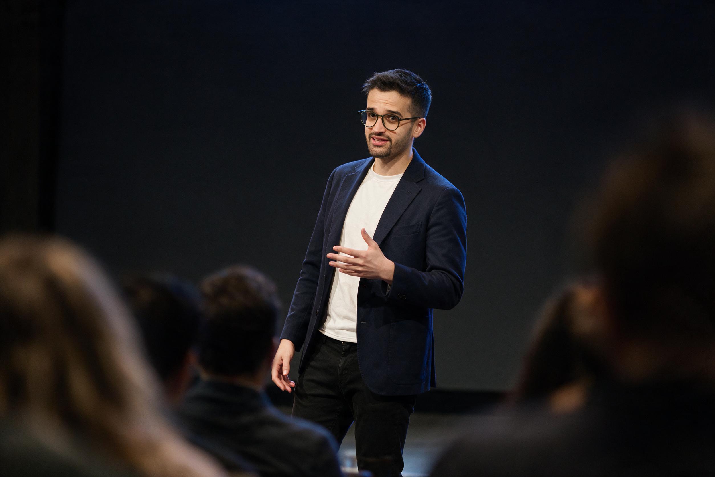 AI-generated image of Pooria Arab — speaking-on-stage